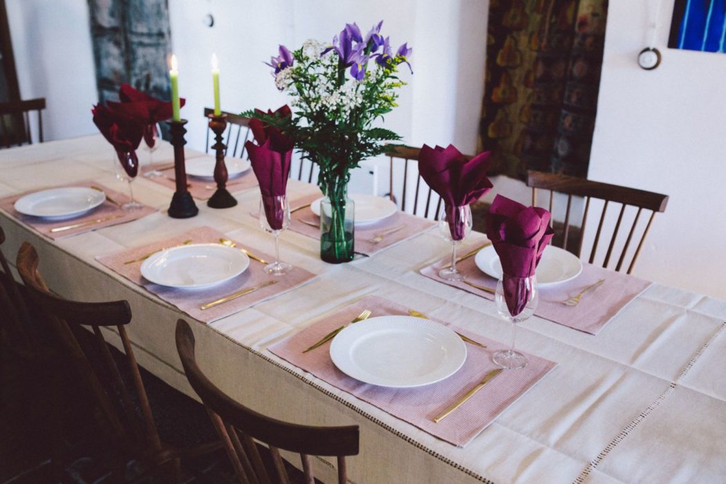 Spanish villa dining table with green candles and red napkins