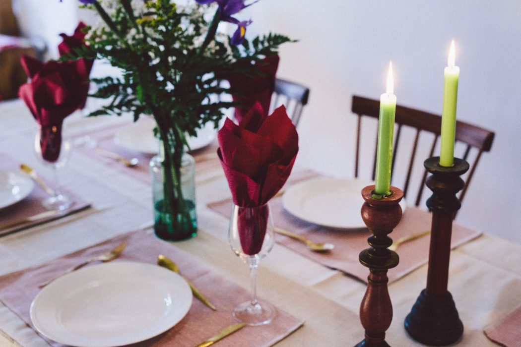 Dining table with green candles and red napkins