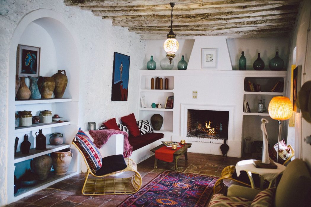 Spanish villa living room with fireplace and antique ceramics.